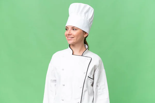Junge Köchin Über Isolierten Grünen Hintergrund — Stockfoto