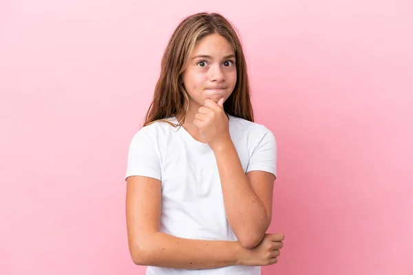 stock image Little caucasian girl isolated on pink background having doubts and thinking