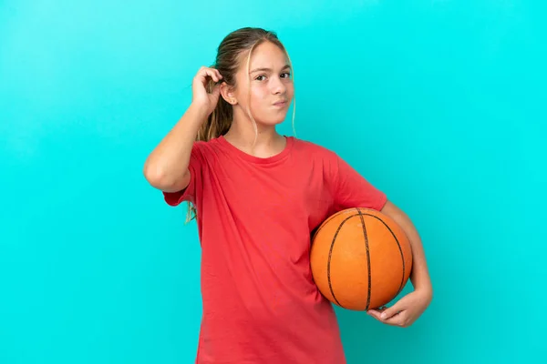Little Caucasian Girl Playing Basketball Isolated Blue Background Having Doubts — Stock Photo, Image