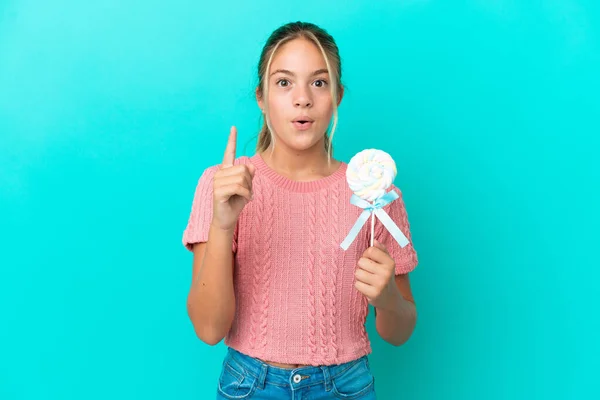 Little Caucasian Girl Holding Lollipop Isolated Blue Background Intending Realizes — Stockfoto