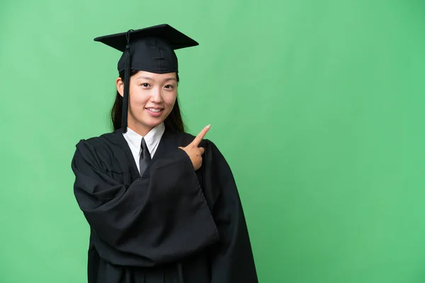 製品を提示するために側面を指して隔離された背景に若い大学院生アジアの女性 — ストック写真