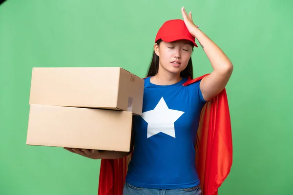 stock image Super Hero delivery Asian woman holding boxes over isolated background has realized something and intending the solution