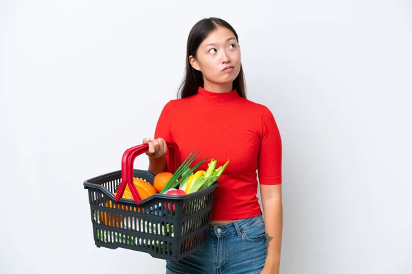 Young Asian Woman Holding Shopping Basket Full Food Isolated White — Stockfoto