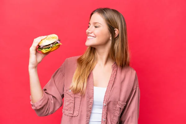 Young Caucasian Woman Holding Burger Isolated Red Background Happy Expression — Foto de Stock