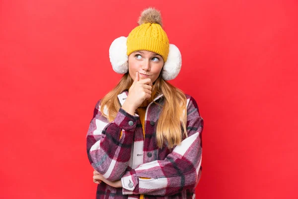 Young Beautiful Woman Wearing Winter Muffs Isolated Red Background Having — Stock Photo, Image