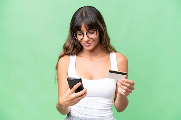 Young Caucasian Woman Isolated Background Buying Mobile Credit Card — Stok fotoğraf