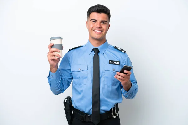 stock image Young police caucasian man isolated on white background holding coffee to take away and a mobile