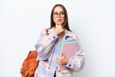 Young beautiful student woman isolated on white background having doubts