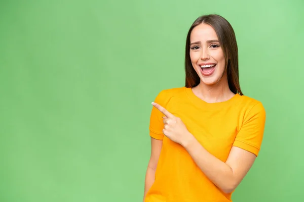 stock image Young pretty caucasian woman over isolated background surprised and pointing side