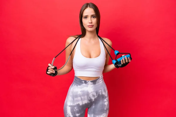 Young Beautiful Caucasian Woman Isolated Red Background Jumping Rope — Stock Fotó