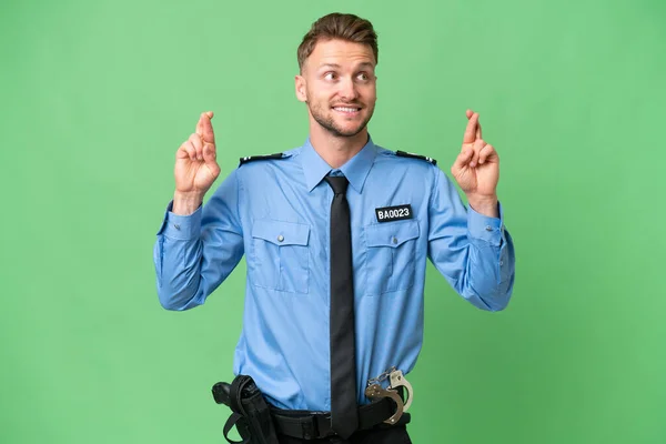 Joven Policía Sobre Fondo Aislado Con Dedos Cruzando —  Fotos de Stock