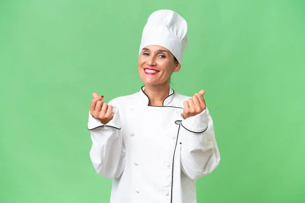 Middle Aged Chef Woman Isolated Background Making Money Gesture — Stock Photo, Image