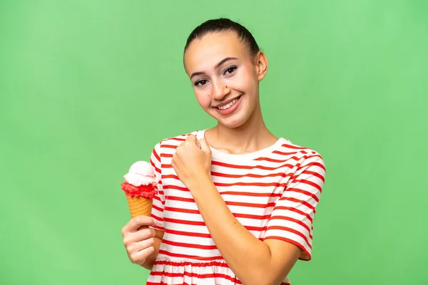 stock image Young Arab woman with a cornet ice cream over isolated background celebrating a victory