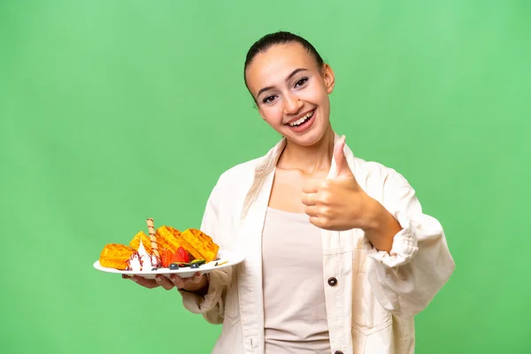 Young Arab Woman Holding Waffles Isolated Background Thumbs Because Something — Stock Photo, Image