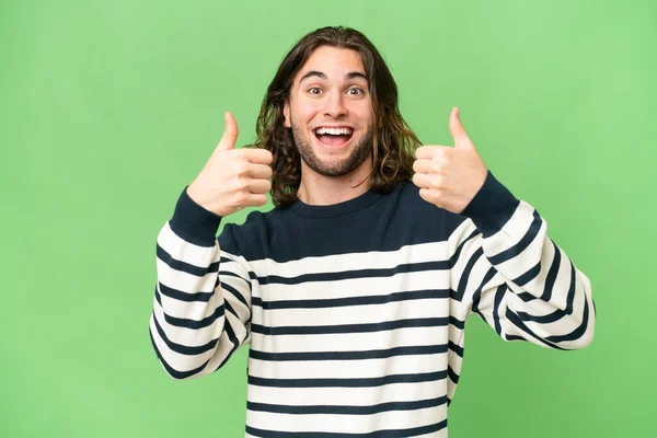 stock image Young handsome man over isolated background giving a thumbs up gesture