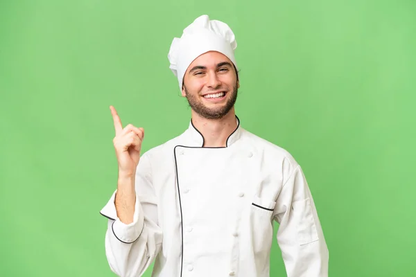 Jovem Bonito Chef Homem Sobre Fundo Isolado Mostrando Levantando Dedo — Fotografia de Stock