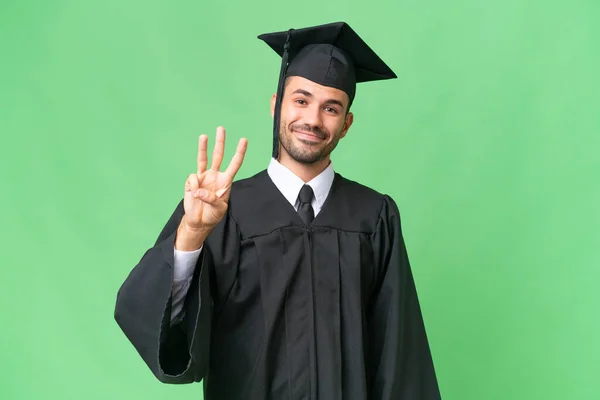 Młody Absolwent Uniwersytetu Człowiek Odosobnionym Tle Szczęśliwy Liczyć Trzy Palce — Zdjęcie stockowe