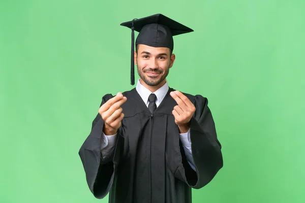 Jovem Universitário Graduado Homem Sobre Isolado Fundo Fazendo Dinheiro Gesto — Fotografia de Stock