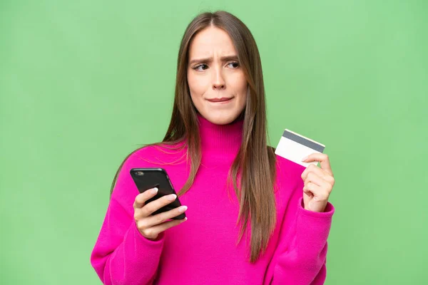 Young Beautiful Caucasian Woman Isolated Background Buying Mobile Credit Card Stock Photo