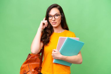 Young student caucasian woman over isolated background thinking an idea