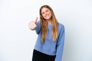 Genç sarışın kadın beyaz arka planda izole edildi. Başparmakları havada çünkü iyi bir şey oldu.