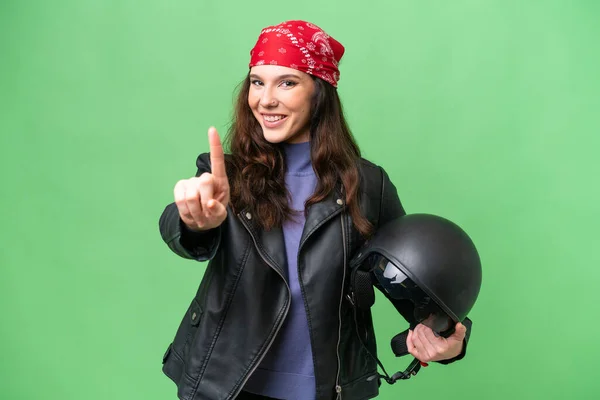 若いですCaucasian女性とともにオートバイヘルメット上の隔離された背景ショーと持ち上げ指 — ストック写真