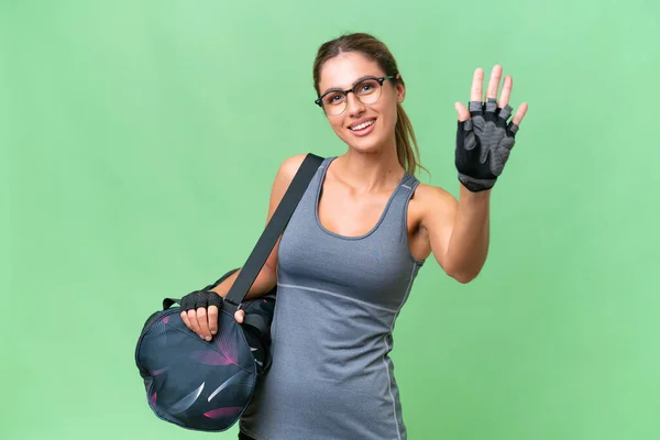 Pretty Young Uruguayan Sport Woman Sport Bag Isolated Background Saluting — Stock Photo, Image
