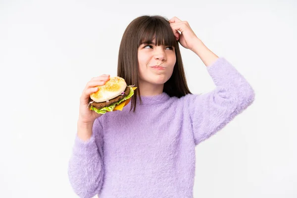 Little Caucasian Girl Holding Burger Isolated Background Having Doubts Confuse — Stock Photo, Image