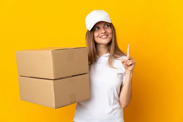 stock image Young Slovak delivery woman isolated on yellow background pointing up a great idea
