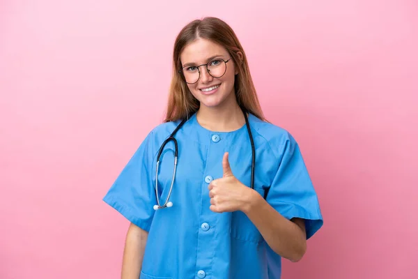 stock image Young surgeon doctor woman isolated on pink background giving a thumbs up gesture