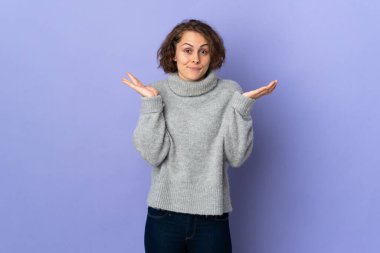 Young English woman isolated on purple background having doubts while raising hands