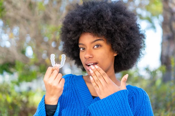 African American Girl Outdoors Holding Invisible Braces Surprised Expression — Stock Photo, Image