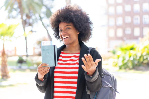 African American Girl Outdoors Holding Passport Doing Coming Gesture — Stock Photo, Image