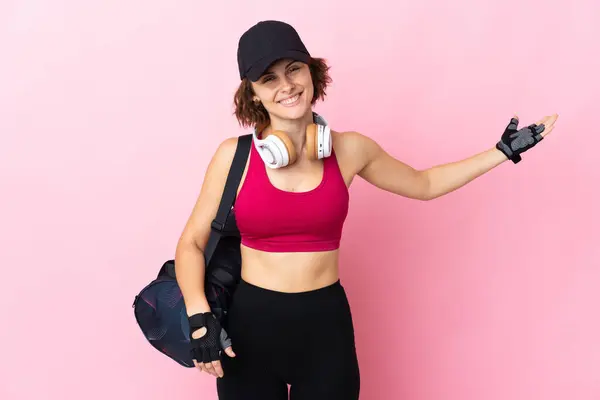 Young Sport Woman Sport Bag Isolated Background Extending Hands Side — стоковое фото