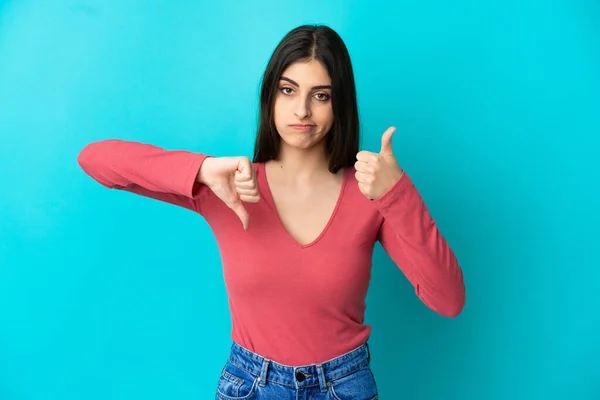 Young Caucasian Woman Isolated Blue Background Making Good Bad Sign — Stock Photo, Image