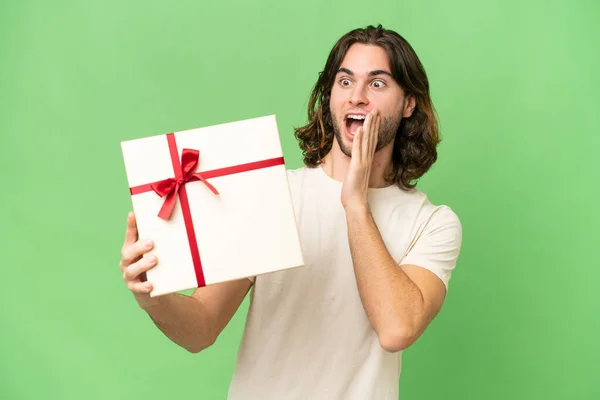 Young Handsome Man Holding Gift Isolated Background Surprise Shocked Facial — Stock Photo, Image