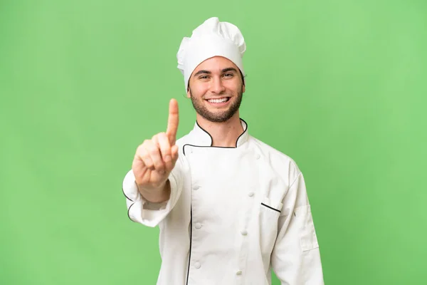 Jovem Bonito Chef Homem Sobre Isolado Fundo Mostrando Levantando Dedo — Fotografia de Stock