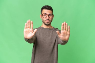 Genç, yakışıklı, beyaz bir adam izole edilmiş geçmişinde durup jest yapıyor ve hayal kırıklığına uğruyor.