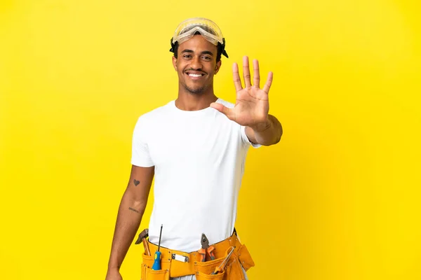 African American electrician man over isolated yellow wall counting five with fingers