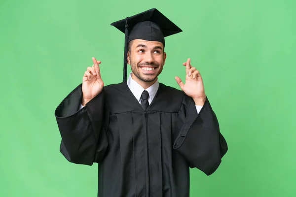 Mladá Univerzita Absolvent Muž Přes Izolované Pozadí Prsty Křížení — Stock fotografie