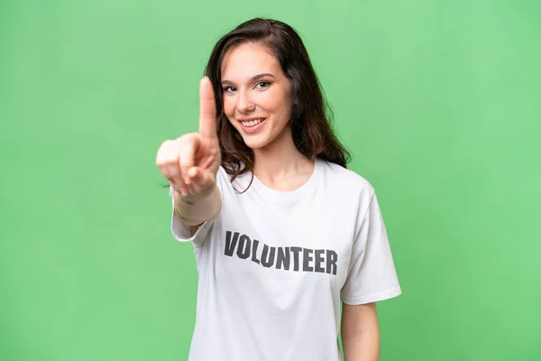 Joven Voluntaria Caucásica Mujer Sobre Aislado Fondo Mostrando Levantando Dedo — Foto de Stock