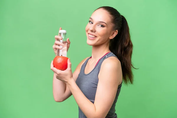 リンゴと水のボトルで隔離された背景に若い白人女性 — ストック写真