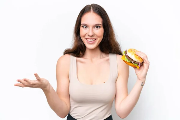 Young Caucasian Woman Holding Burger Isolated White Background Shocked Facial — Stock Photo, Image