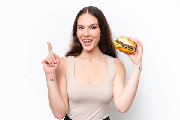 Young Caucasian Woman Holding Burger Isolated White Background Pointing Great — Stock Photo, Image