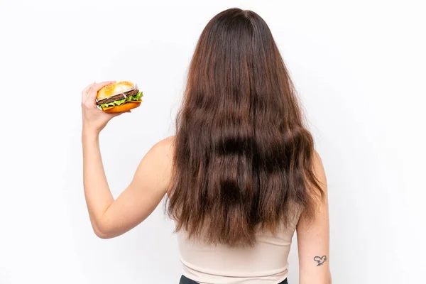 Young Caucasian Woman Holding Burger Isolated White Background Back Position — Foto de Stock