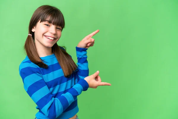 stock image Little caucasian girl over isolated background pointing finger to the side and presenting a product