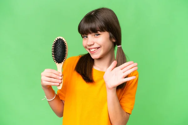 Little Caucasian Girl Hair Comb Isolated Background Saluting Hand Happy — Stock Photo, Image