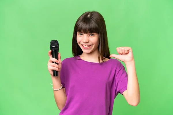 Little Singer Girl Picking Microphone Isolated Background Proud Self Satisfied — Stock Photo, Image