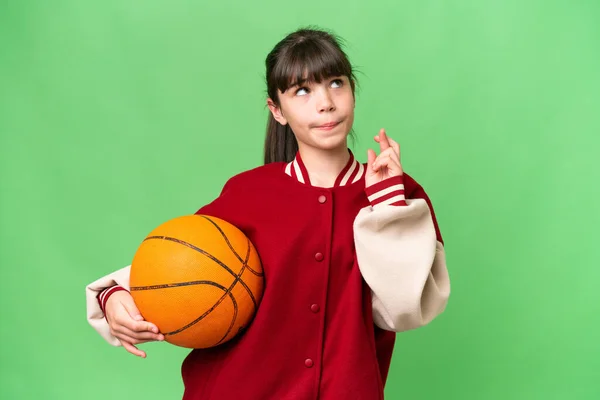 stock image Little caucasian girl playing basketball over isolated background with fingers crossing and wishing the best