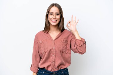 Young pretty caucasian woman isolated on white background showing ok sign with fingers